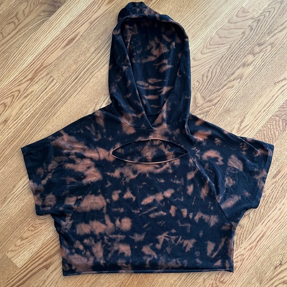 a Ellen black bleach died, cropped hoodie with chest cut out. Size medium.